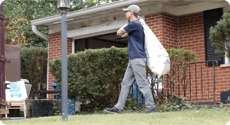 man hauling trash away